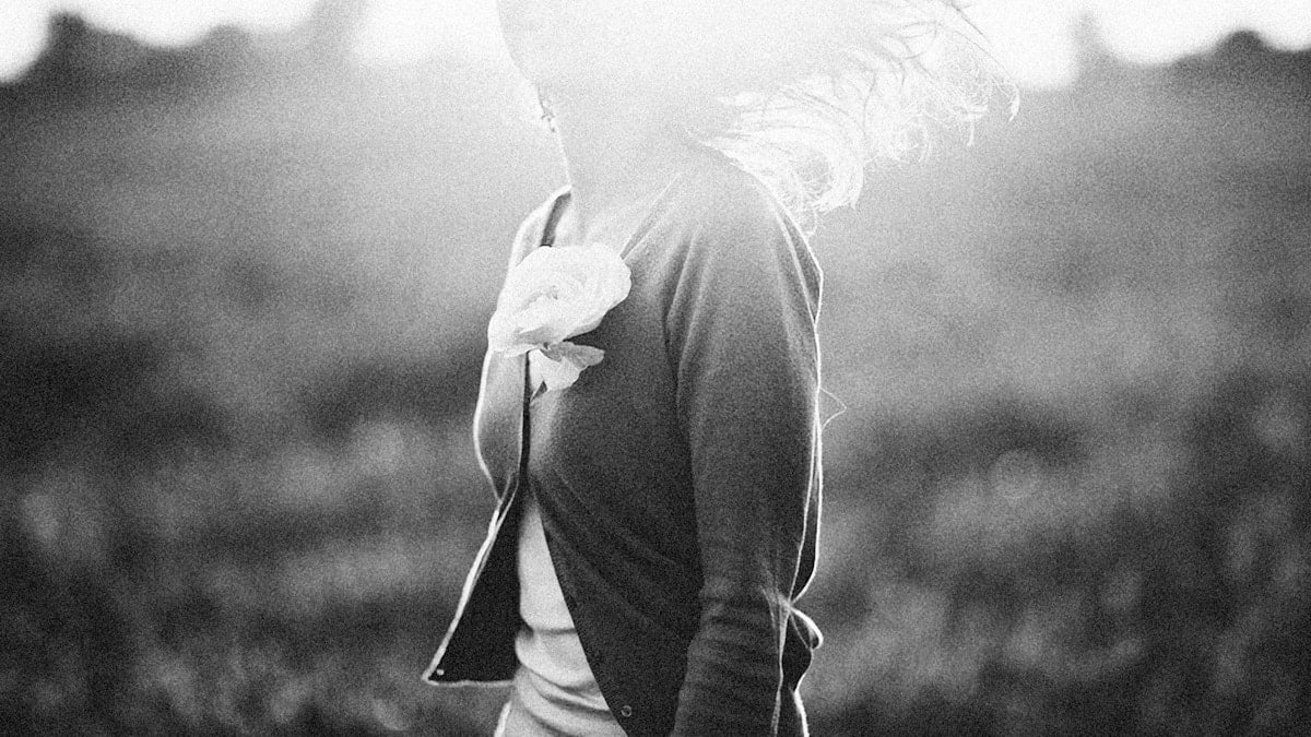 a black and white photo of a woman with her back to the camera